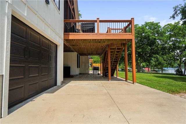 38 Lakeview Ln, Linn Valley, KS 66040 - view of patio / terrace featuring stairs, an attached garage, a wooden deck, and concrete driveway