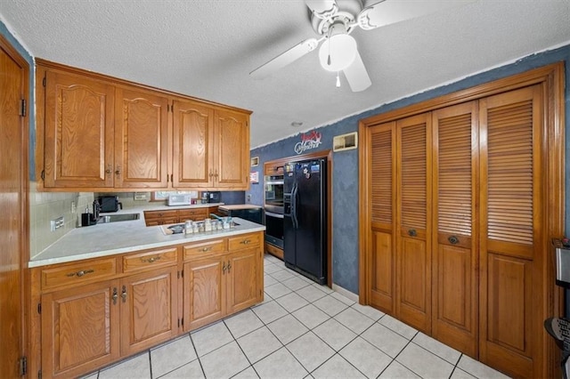 4401 N Holmes St, Kansas City, MO 64116 - kitchen with a textured ceiling, black refrigerator with ice dispenser, brown cabinetry, light countertops, and light tile patterned floors