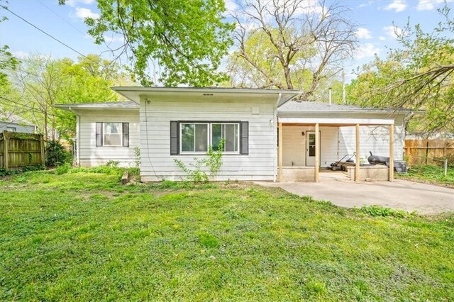 4401 N Holmes St, Kansas City, MO 64116 - back of house with a yard, a patio, and fence