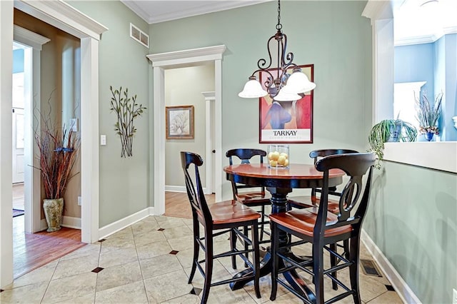 3205 SW Rockbridge Dr, Lees Summit, MO 64081 - dining area with light tile patterned floors, ornamental molding, a chandelier, and visible vents