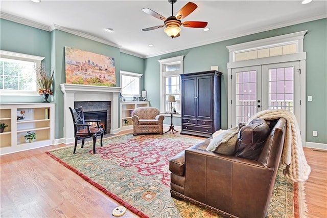 3205 SW Rockbridge Dr, Lees Summit, MO 64081 - living room with ornamental molding, a ceiling fan, wood finished floors, and a wealth of natural light