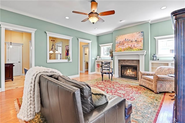 3205 SW Rockbridge Dr, Lees Summit, MO 64081 - living area featuring ornamental molding, wood finished floors, recessed lighting, a tiled fireplace, and a ceiling fan