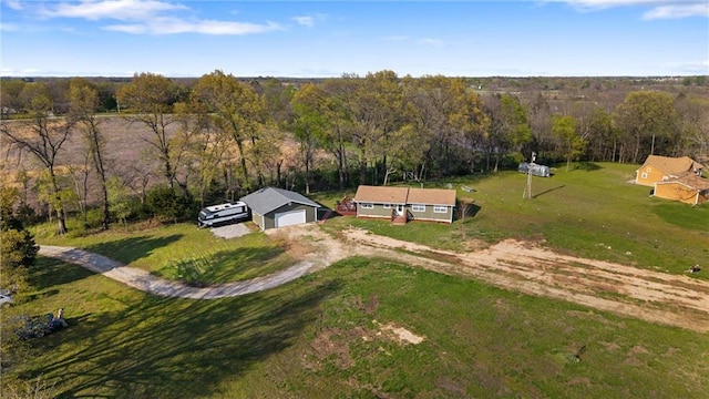 birds eye view of property featuring a wooded view