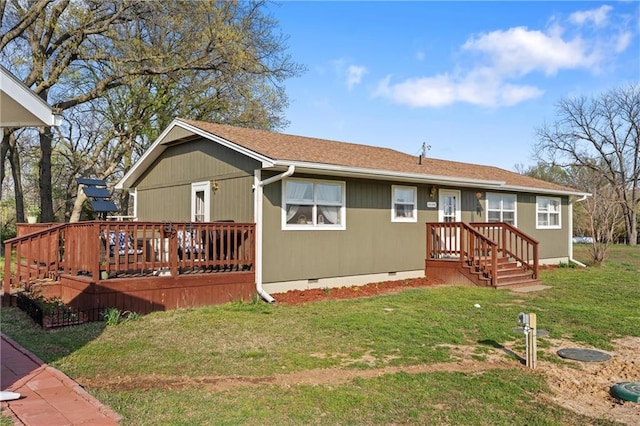 rear view of property featuring a yard, a deck, crawl space, and a shingled roof