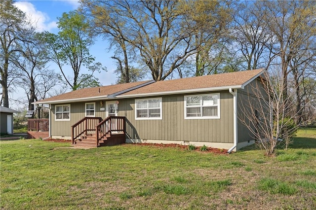 ranch-style home featuring crawl space, a shingled roof, and a front lawn