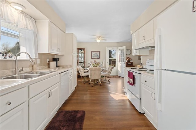 kitchen with white cabinets, white appliances, light countertops, and a sink
