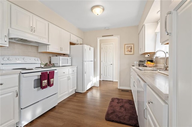 kitchen featuring white cabinets, under cabinet range hood, white appliances, and light countertops