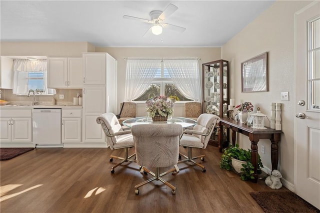 dining space with dark wood-style flooring, a ceiling fan, and a healthy amount of sunlight