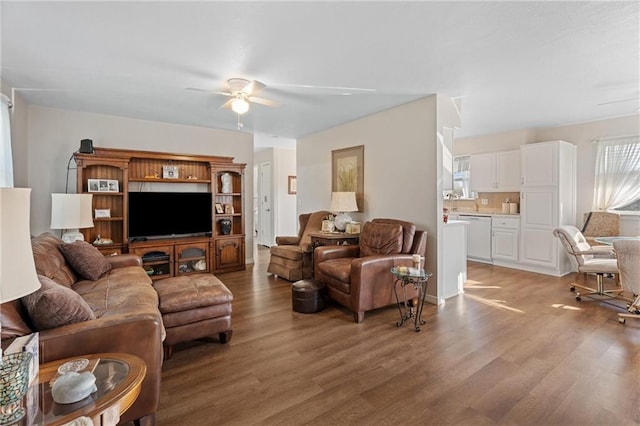 living area featuring light wood-style floors and ceiling fan