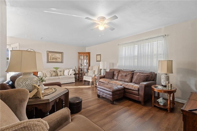living area featuring a ceiling fan and wood finished floors