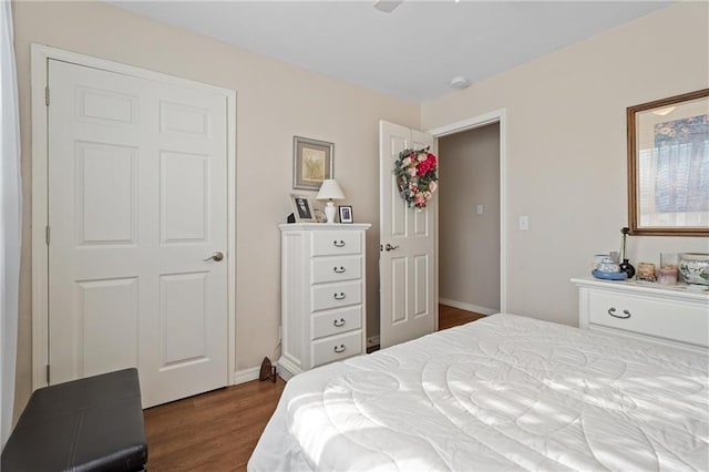 bedroom featuring baseboards and dark wood finished floors