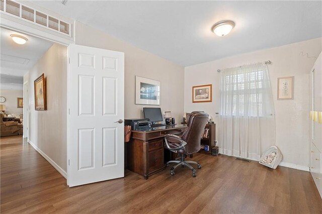 office featuring visible vents, baseboards, and wood finished floors