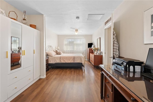 bedroom with a ceiling fan and wood finished floors