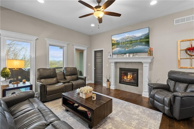 living room with recessed lighting, a fireplace, a ceiling fan, visible vents, and wood finished floors
