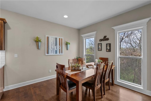 dining area with dark wood-type flooring, baseboards, and recessed lighting
