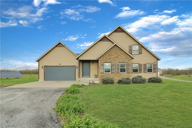 611 NW 1421st Rd, Holden, MO 64040 - view of front of property with asphalt driveway, a garage, a front lawn, and solar panels