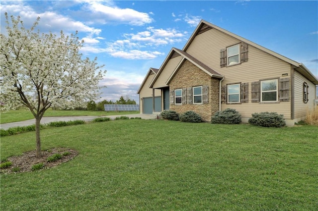 611 NW 1421st Rd, Holden, MO 64040 - view of front of property featuring a garage, stone siding, concrete driveway, and a front lawn