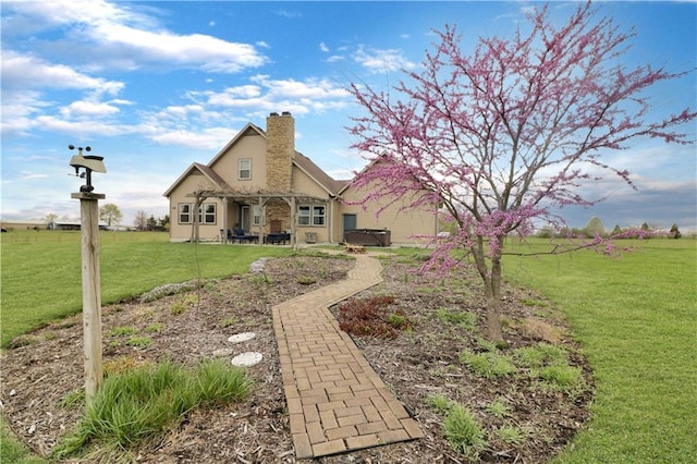 611 NW 1421st Rd, Holden, MO 64040 - back of property with a patio, a yard, a hot tub, and a chimney
