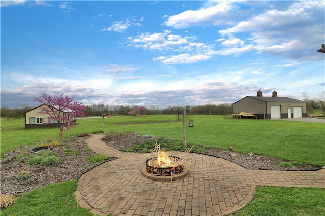 611 NW 1421st Rd, Holden, MO 64040 - view of green lawn with an outdoor fire pit and an outdoor structure