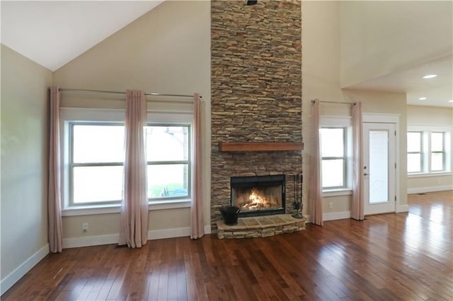 611 NW 1421st Rd, Holden, MO 64040 - unfurnished living room with wood-type flooring, a fireplace, baseboards, and high vaulted ceiling