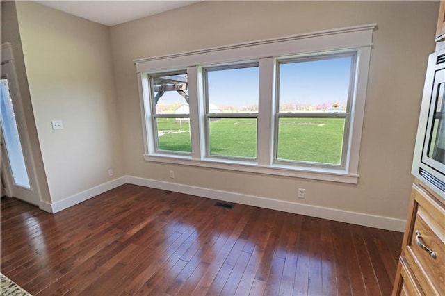 611 NW 1421st Rd, Holden, MO 64040 - spare room with baseboards and dark wood finished floors