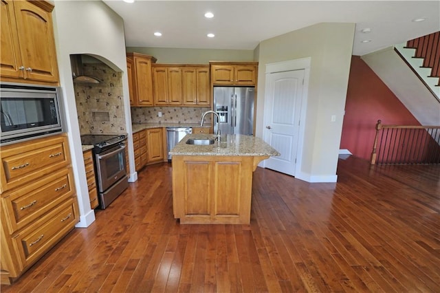 611 NW 1421st Rd, Holden, MO 64040 - kitchen featuring appliances with stainless steel finishes, a sink, a kitchen island with sink, light stone counters, and dark wood-style floors