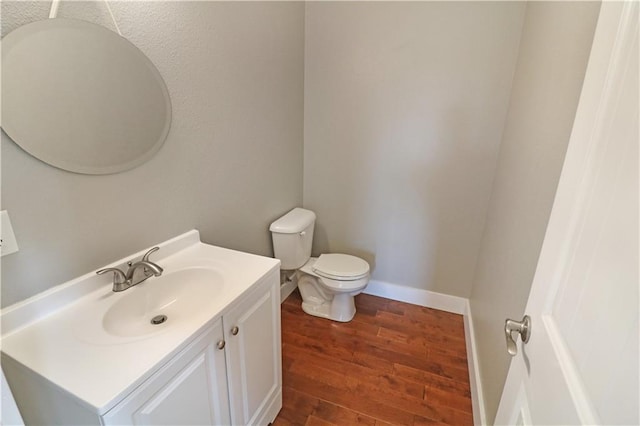 611 NW 1421st Rd, Holden, MO 64040 - bathroom with vanity, toilet, wood finished floors, and baseboards