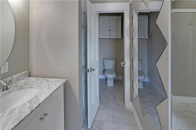 611 NW 1421st Rd, Holden, MO 64040 - bathroom with marble finish floors, toilet, baseboards, and vanity