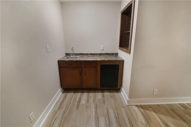 611 NW 1421st Rd, Holden, MO 64040 - indoor wet bar featuring light wood-style floors and baseboards