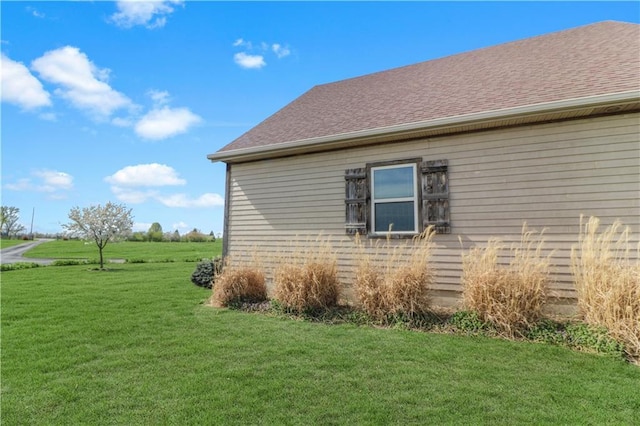 611 NW 1421st Rd, Holden, MO 64040 - view of side of home with a lawn and a shingled roof