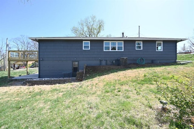 back of house with a yard, central AC, and a deck