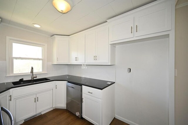 kitchen with dishwasher, a sink, visible vents, and dark countertops