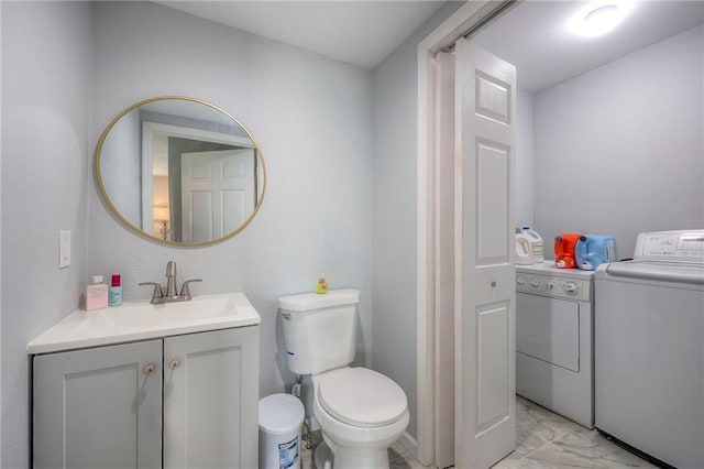1610 E 37th St, Kansas City, MO 64109 - half bath featuring marble finish floor, washer and clothes dryer, vanity, and toilet
