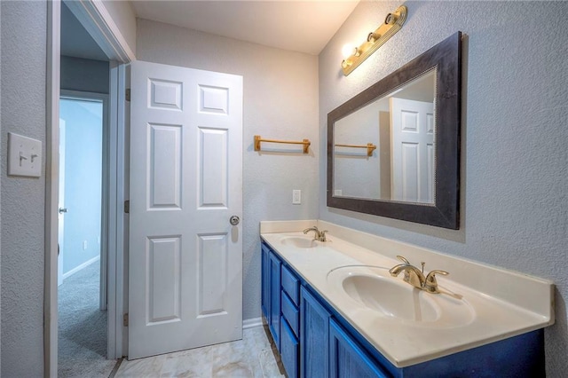 1610 E 37th St, Kansas City, MO 64109 - bathroom with a textured wall, a sink, and double vanity