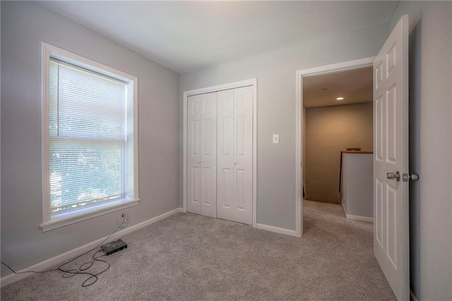 1610 E 37th St, Kansas City, MO 64109 - unfurnished bedroom featuring carpet, a closet, and baseboards