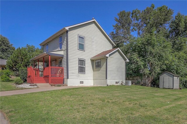 1610 E 37th St, Kansas City, MO 64109 - exterior space featuring crawl space, a yard, a storage unit, and covered porch
