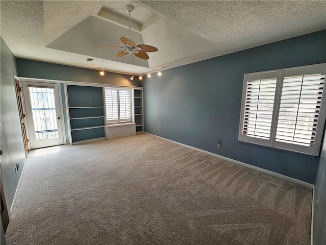 301 E Partridge Ave Unit K, Independence, MO 64055 - carpeted spare room with a textured ceiling, ceiling fan, rail lighting, and baseboards