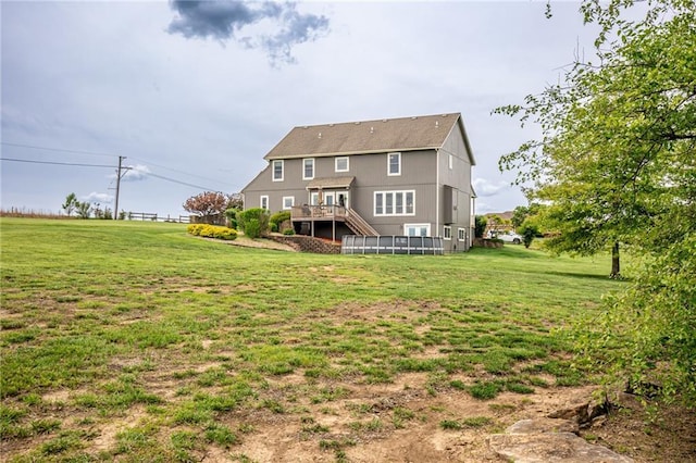 25477 Crestview Dr, Paola, KS 66071 - rear view of house with a lawn and a deck