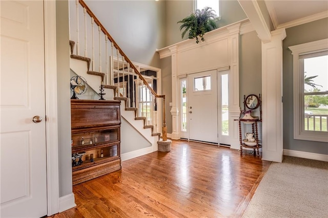 25477 Crestview Dr, Paola, KS 66071 - foyer entrance featuring stairs, ornamental molding, wood finished floors, and baseboards