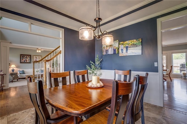 25477 Crestview Dr, Paola, KS 66071 - dining room with ornamental molding, wainscoting, a ceiling fan, and stone finish floors