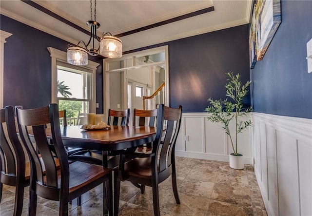 25477 Crestview Dr, Paola, KS 66071 - dining space with a decorative wall, crown molding, stone tile flooring, and a wainscoted wall