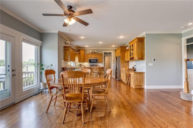 25477 Crestview Dr, Paola, KS 66071 - dining area featuring light wood-style flooring, crown molding, ceiling fan, recessed lighting, and baseboards
