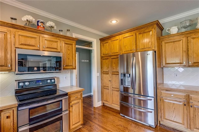 25477 Crestview Dr, Paola, KS 66071 - kitchen featuring appliances with stainless steel finishes, tasteful backsplash, light countertops, crown molding, and brown cabinets
