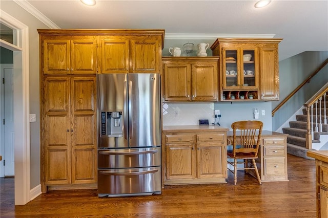 25477 Crestview Dr, Paola, KS 66071 - kitchen featuring stainless steel fridge with ice dispenser, brown cabinets, ornamental molding, dark wood-style floors, and glass insert cabinets