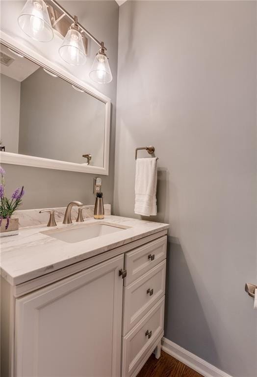 25477 Crestview Dr, Paola, KS 66071 - bathroom with vanity, baseboards, and wood finished floors
