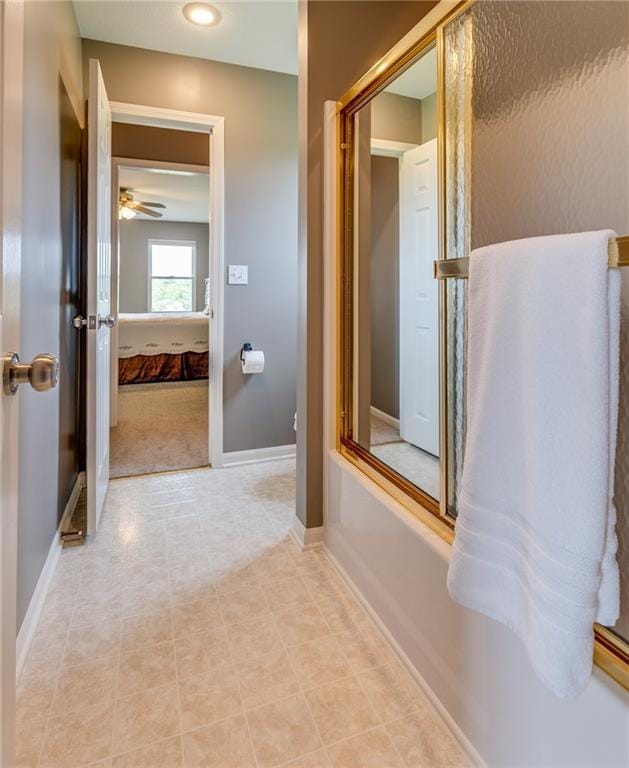 25477 Crestview Dr, Paola, KS 66071 - bathroom with ensuite bathroom, a ceiling fan, and baseboards