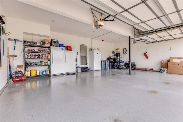 25477 Crestview Dr, Paola, KS 66071 - garage with a garage door opener and freestanding refrigerator