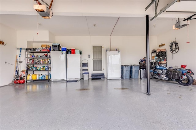 25477 Crestview Dr, Paola, KS 66071 - garage with freestanding refrigerator and a garage door opener