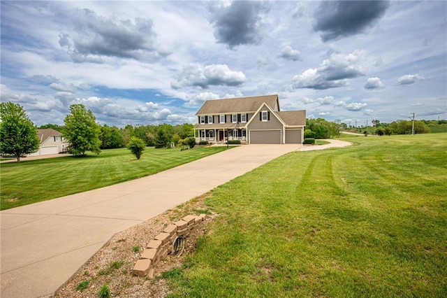 25477 Crestview Dr, Paola, KS 66071 - view of front facade with concrete driveway, an attached garage, and a front yard