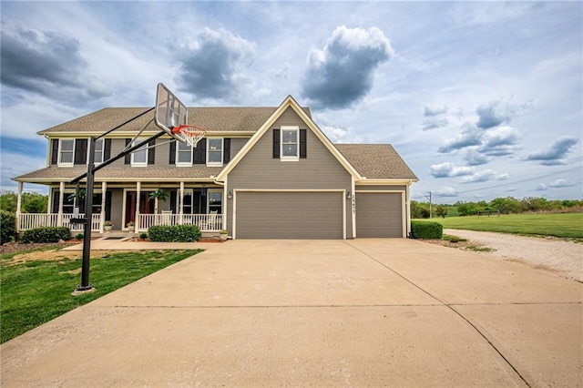25477 Crestview Dr, Paola, KS 66071 - view of front of property with a porch, driveway, a front lawn, and a garage